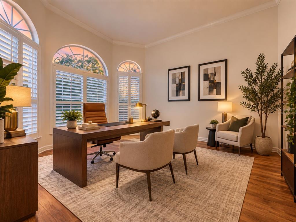A home office featuring a desk, sofa, coffee table, and an upright piano on wood floors — 1648 MARINA LAKE DRIVE, KISSIMMEE, FL