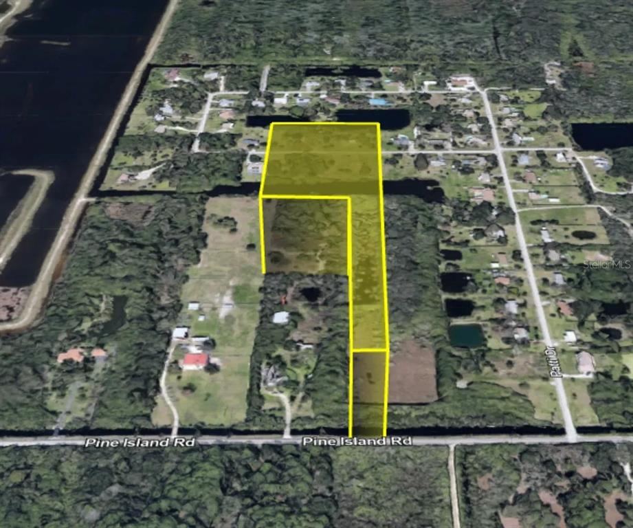 An aerial view shows a yellow-highlighted L-shaped parcel of land bordering Pine Island Road — TBD PINE ISLAND ROAD, MERRITT ISLAND, FL