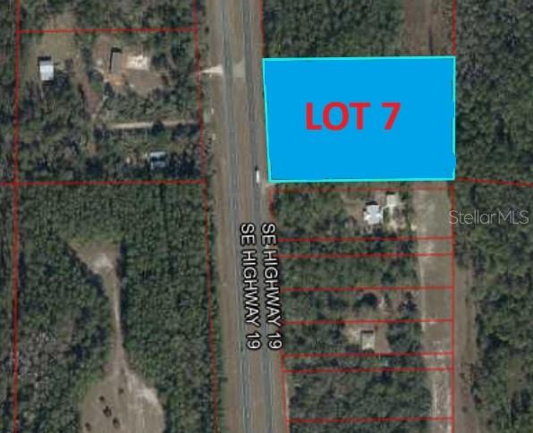 An aerial map shows a rectangular parcel of land labeled Lot 7 next to a highway — TBD US 19, INGLIS, FL