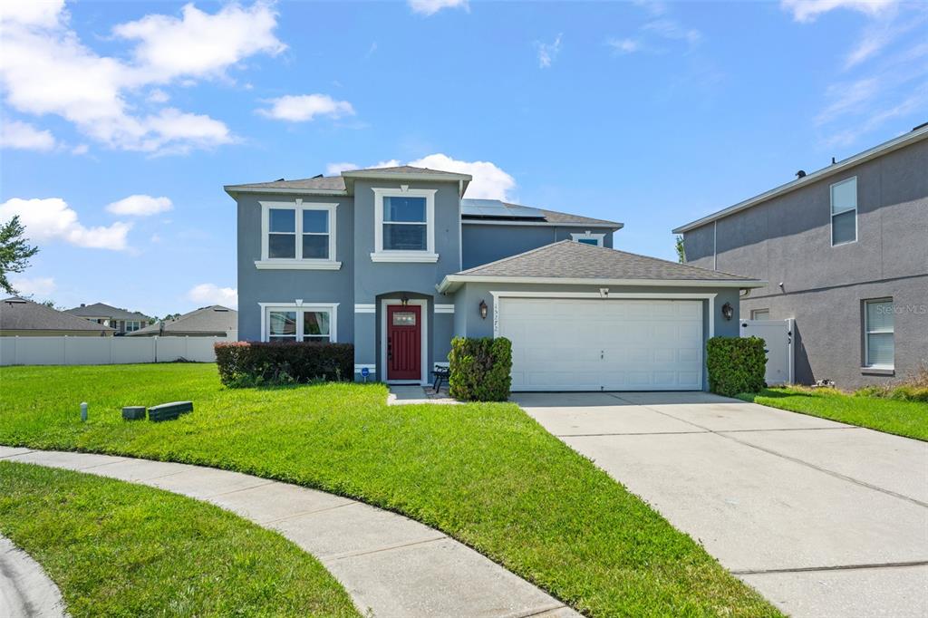 A two-story gray house with a red front door and an attached two-car garage — 15272 SUGARGROVE WAY, ORLANDO, FL