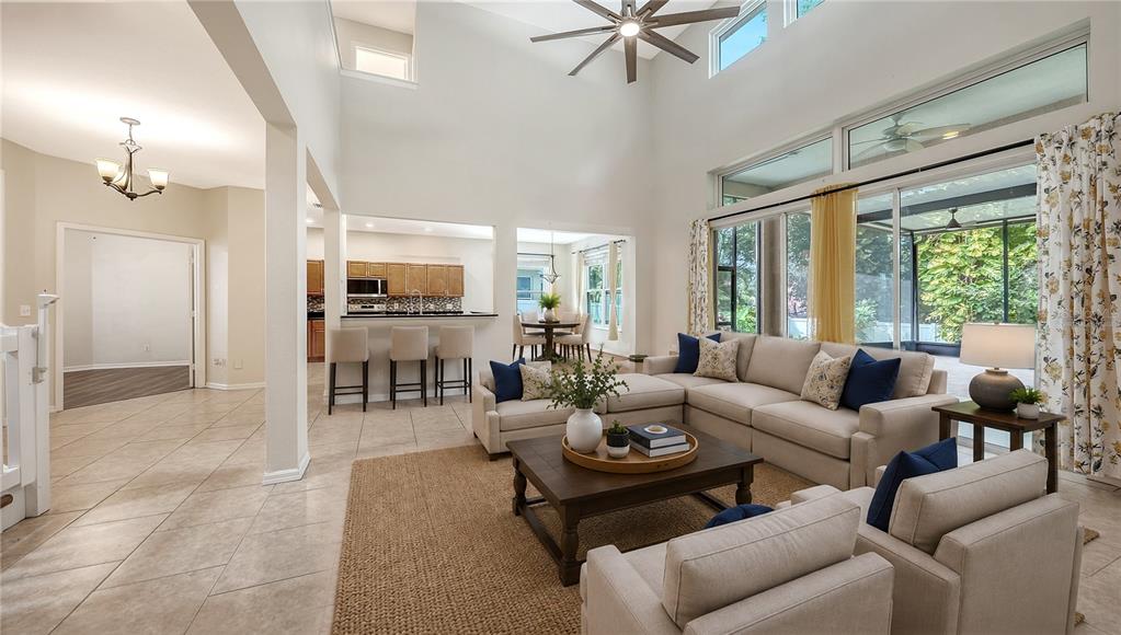 A two-story house with a pink garage door, a concrete driveway, and a front yard — 208 36TH STREET NE, BRADENTON, FL