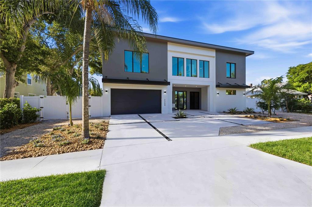 An aerial view of a modern two-story house with a flat roof and concrete driveway — 2258 ARLINGTON STREET, SARASOTA, FL