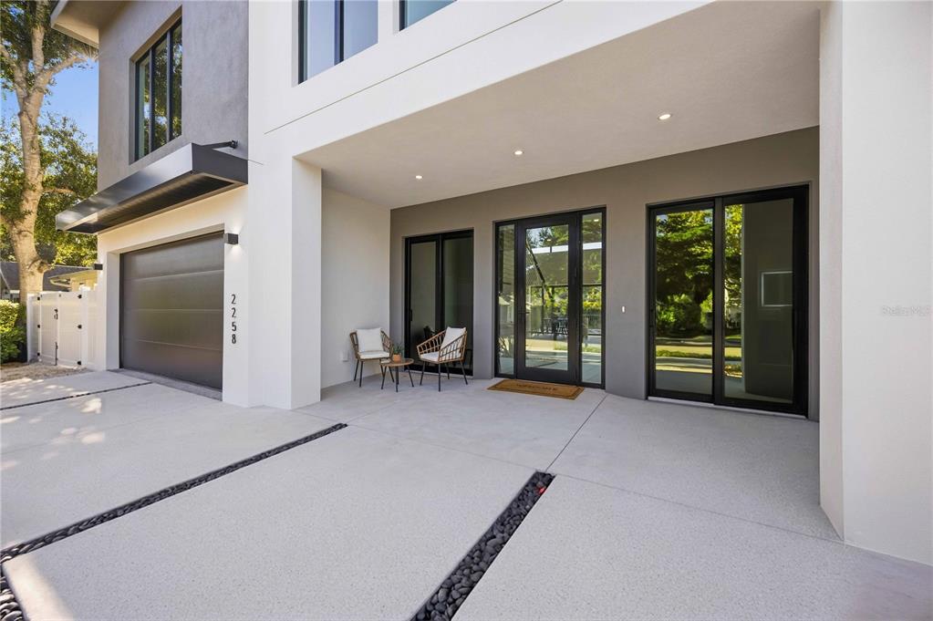 An aerial view shows a house under construction with a large flat roof and driveway — 2258 ARLINGTON STREET, SARASOTA, FL