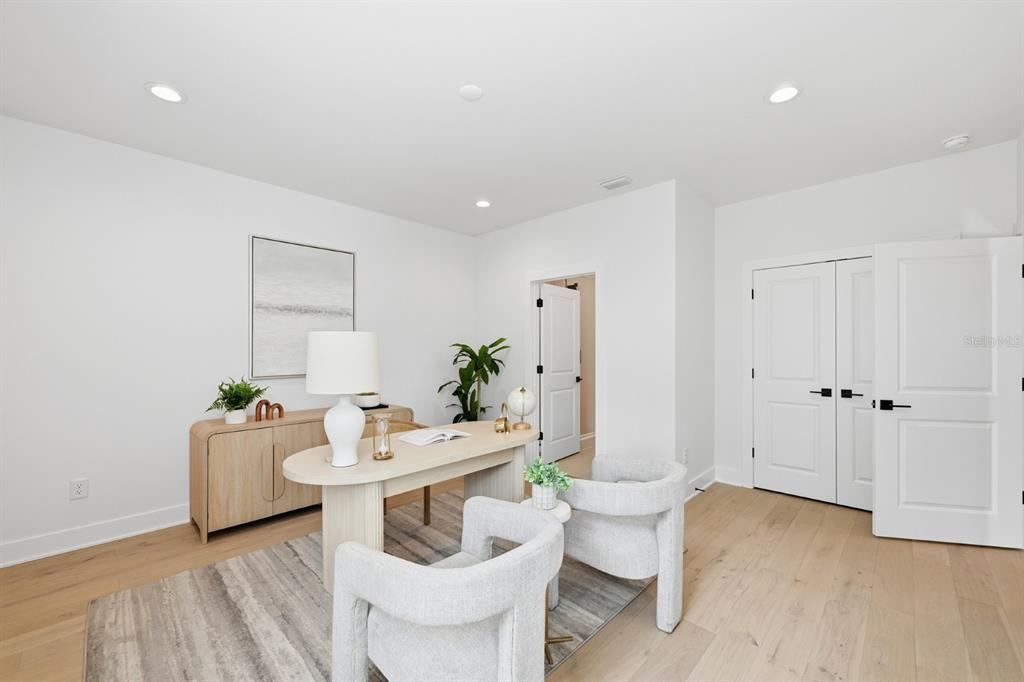 A bright home office features light wood flooring, a modern desk, two chairs, and white walls — 310 W COLUMBUS DRIVE UNIT 3, TAMPA, FL