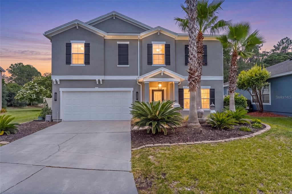 A two-story gray house with a two-car garage and palm trees in the front yard — 48 MISSION OAK COURT, ST AUGUSTINE, FL