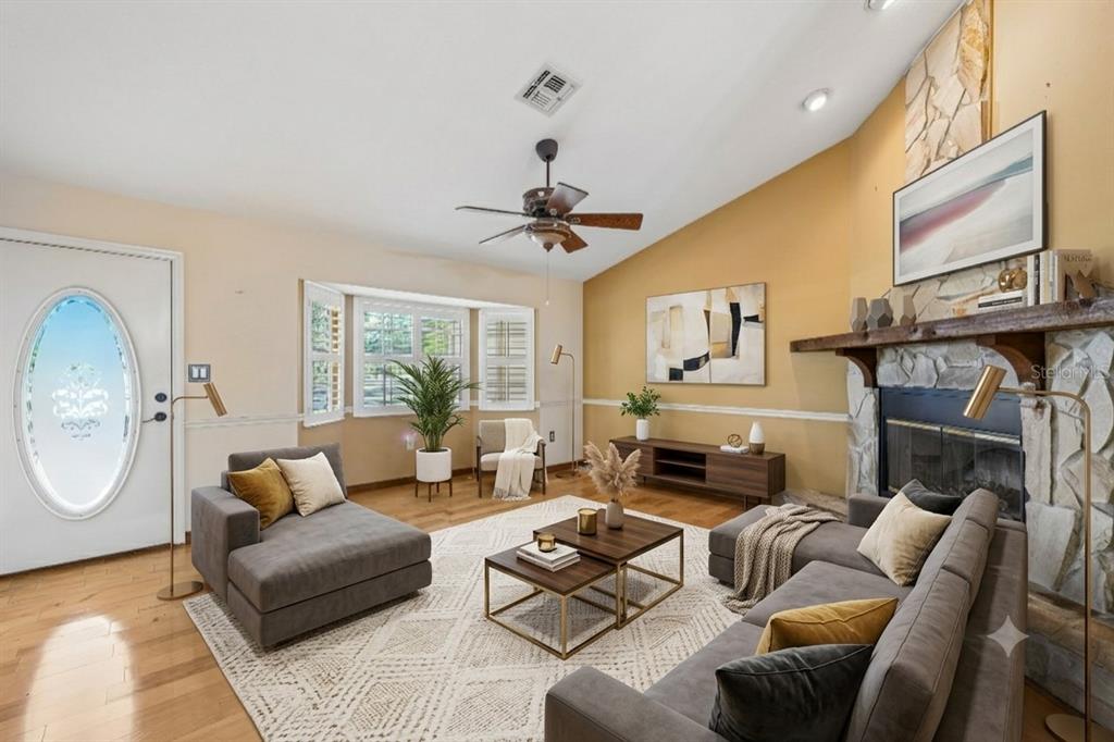 A single-story house sits in a large, grassy yard shaded by several mature oak trees — 204 JEFFERSON DRIVE, LAKE PLACID, FL