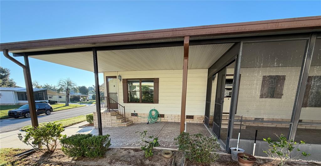 A dining room features a wooden table, four chairs, a hutch, and a hanging lamp — 2532 AMYRIS COURT UNIT 601, ZELLWOOD, FL