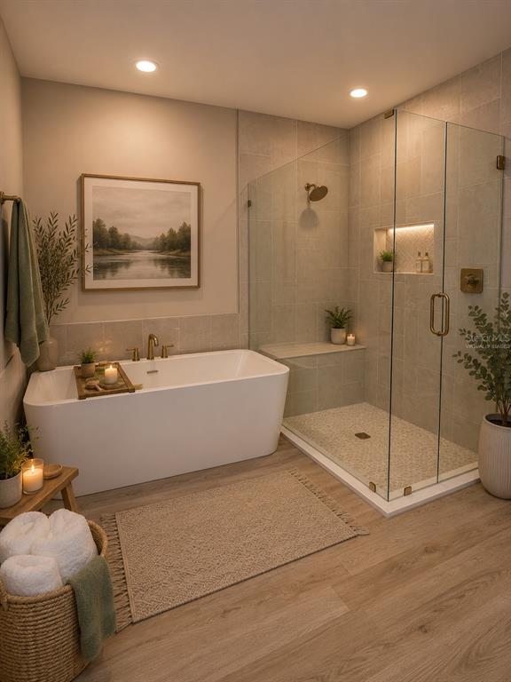 A modern bathroom features a freestanding tub, a glass-enclosed walk-in shower, and wood-look flooring — 6757 SUMMIT VIEW DRIVE, BROOKSVILLE, FL