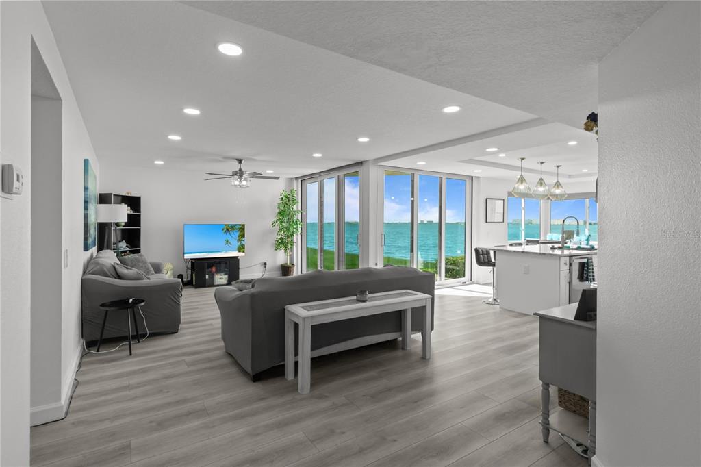 A view from a patio overlooking a grassy lawn, a multi-story building, and the ocean — 5505 LA PUERTA DEL SOL BOULEVARD S UNIT 126, ST PETERSBURG, FL