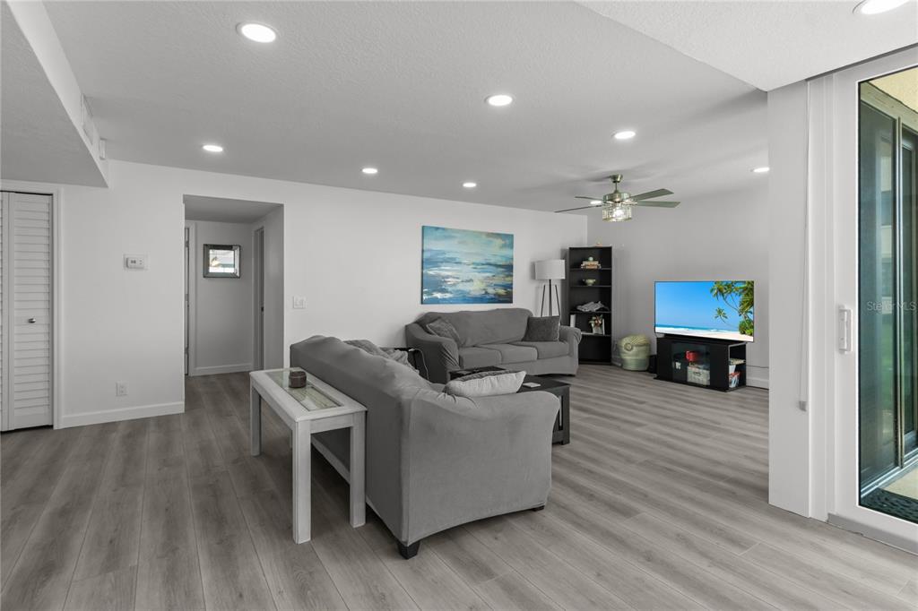 An open-concept living room and kitchen with light wood flooring and a view of water — 5505 LA PUERTA DEL SOL BOULEVARD S UNIT 126, ST PETERSBURG, FL