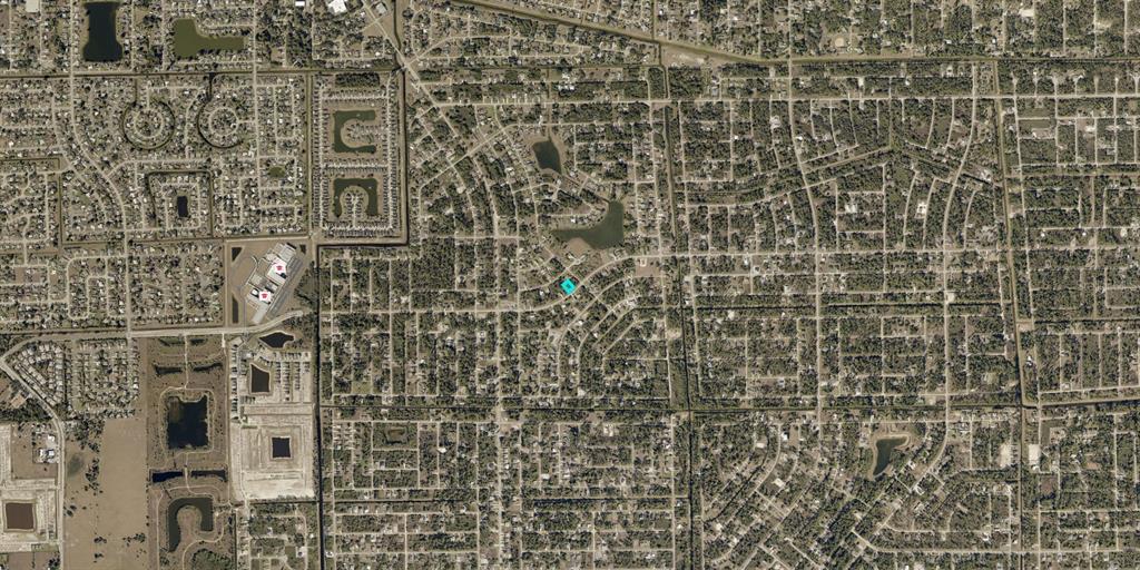This is an aerial map view of a residential neighborhood with a highlighted property lot — 845 SUNRISE BOULEVARD, LEHIGH ACRES, FL