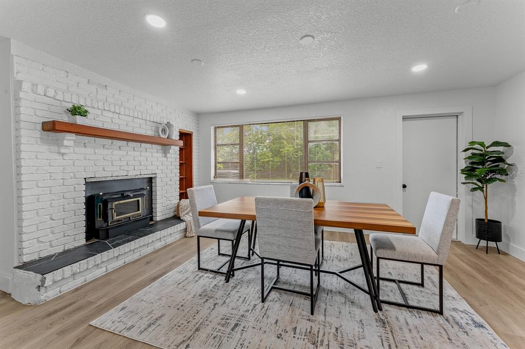 A single-story house with a white exterior, a flat roof, and an attached carport — 849 LOGAN DRIVE, LONGWOOD, FL