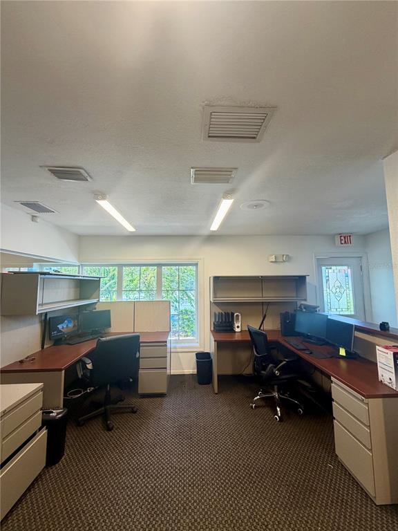 A break room features a folding table with kitchen appliances, water jugs, and a desk fan — 28960 US HIGHWAY 19 N UNIT 102, CLEARWATER, FL