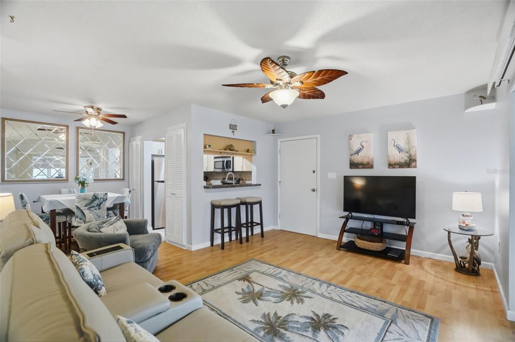 A view from a balcony overlooking a canal with boats, palm trees, and nearby houses — 5108 AMULET DRIVE UNIT 205, NEW PORT RICHEY, FL