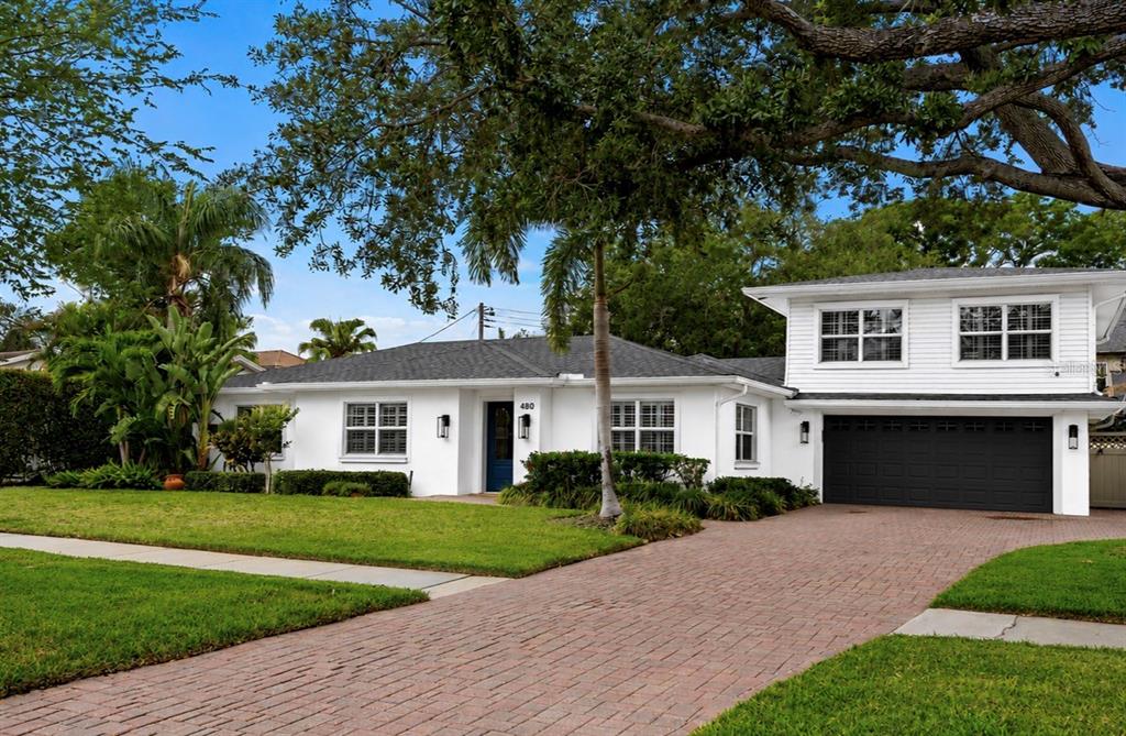 A single-story house with a white exterior, a brick driveway, and a two-car garage — 480 W DAVIS BOULEVARD, TAMPA, FL