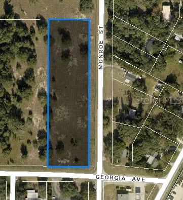 An aerial map view shows a rectangular vacant lot outlined in blue along a street — TBD MONROE STREET, ASTATULA, FL