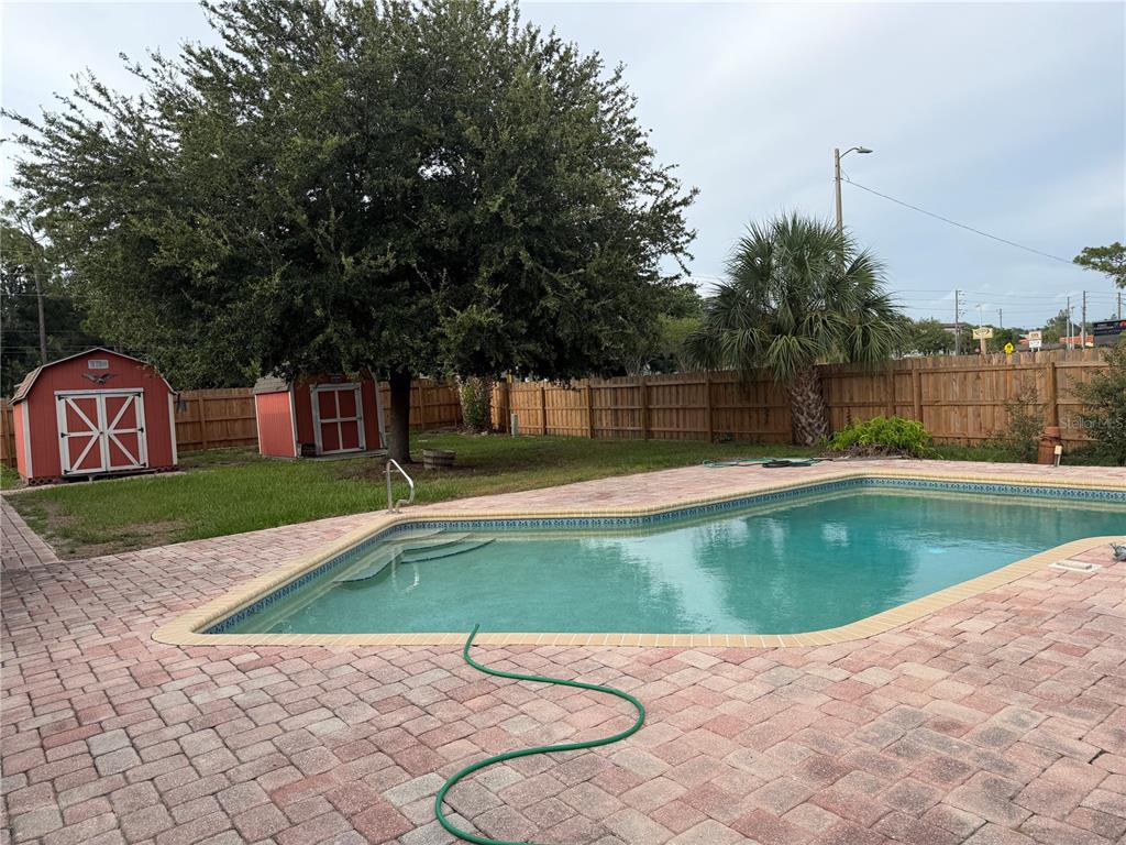 A single-story brick house with a two-car garage and a hedge in the front yard — 7797 132ND WAY, SEMINOLE, FL