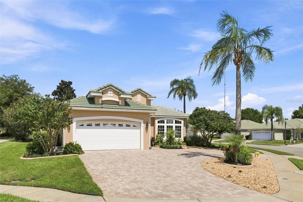 A single-story house with a beige stucco exterior, a two-car garage, and a paved driveway — 367 FOXHILL DRIVE, DEBARY, FL