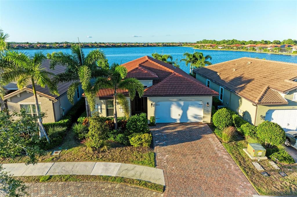 An aerial view of a single-story house with a tile roof and brick driveway — 228 MARAVIYA BOULEVARD, NOKOMIS, FL