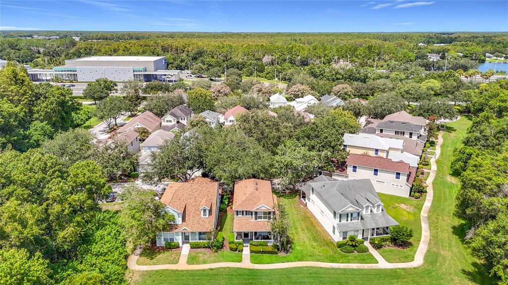 An aerial view shows three suburban houses with green lawns and surrounding trees — 5014 BRIDGEWAY LANE, LUTZ, FL