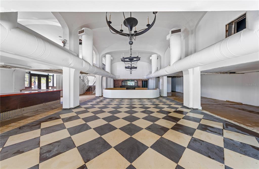 A large, open room features a black-and-white checkered floor, arched ceilings, and two chandeliers — 201-202 TIZOL STREET, SAN JUAN, PR