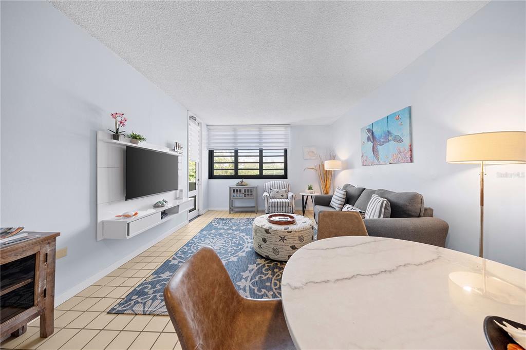A dining area features a round marble table, four chairs, and a ceiling fan — DR BEACH VILLAGE UNIT 119, HUMACAO, PR