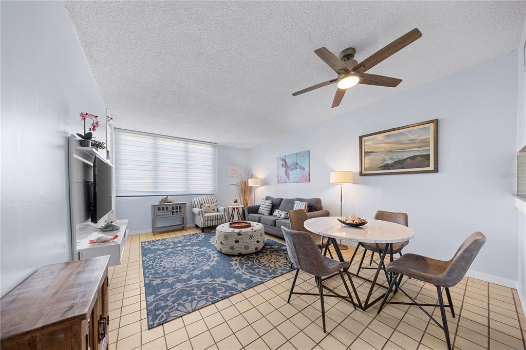 A galley kitchen features white cabinets, dark granite countertops, a double sink, and tiled flooring — DR BEACH VILLAGE UNIT 119, HUMACAO, PR
