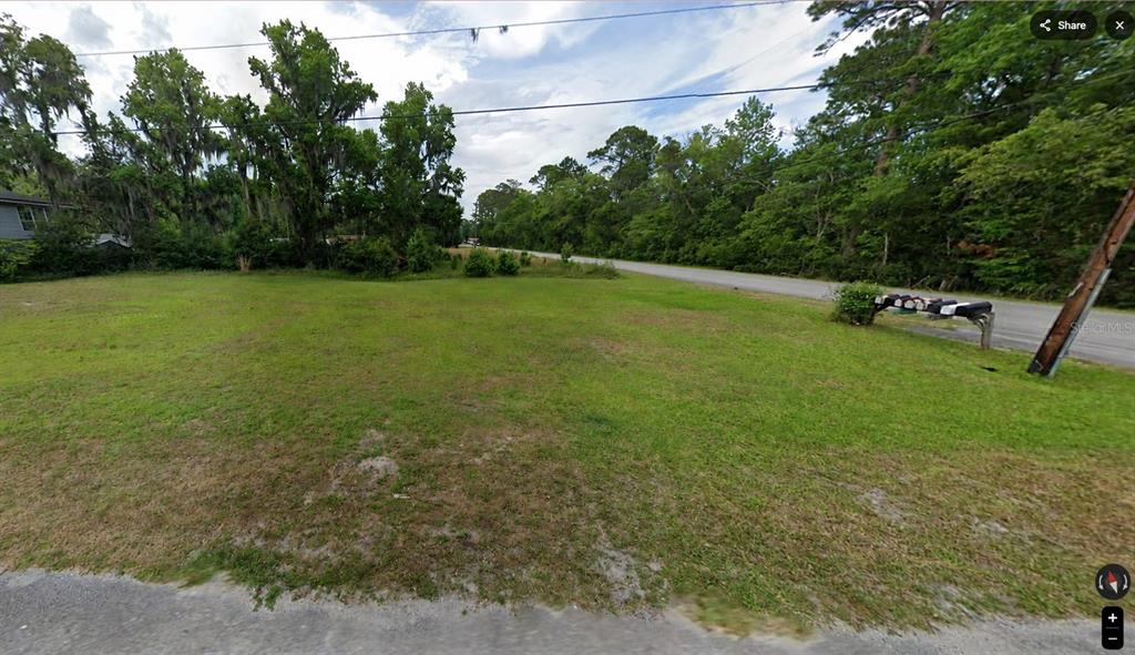 A grassy, vacant lot sits next to a paved road with a row of mailboxes — 110 JESSE ROAD, ST AUGUSTINE, FL