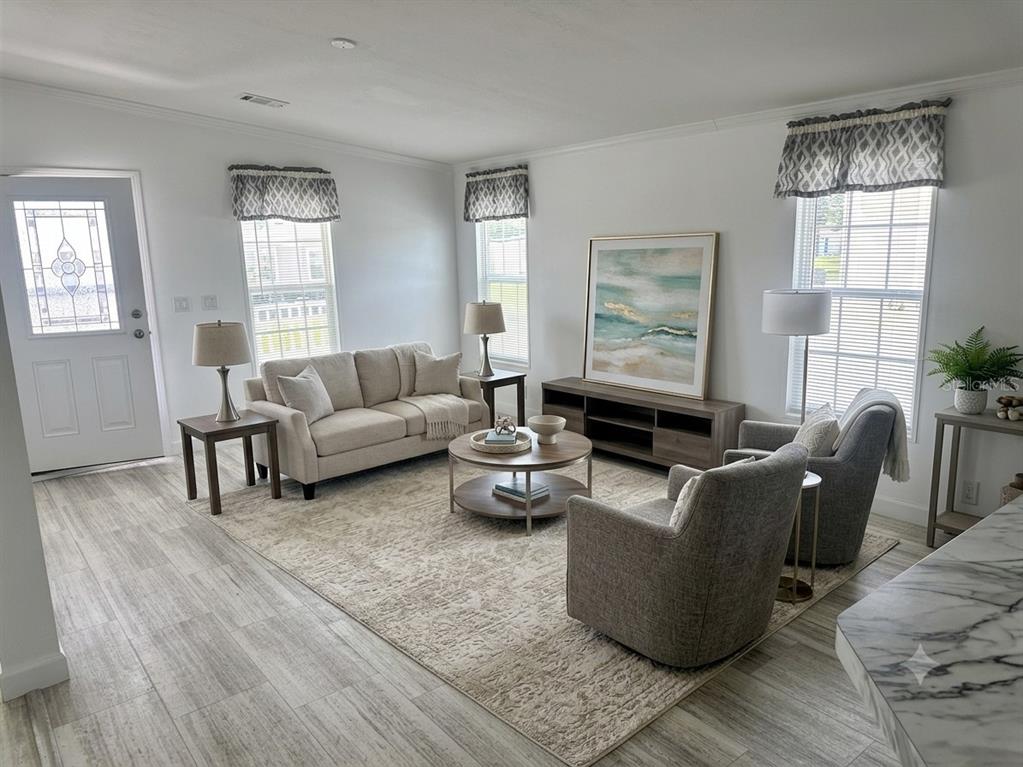 A kitchen features a marble-topped island, light-colored cabinetry, and dark tile backsplash — 3496 GREENBLUFF ROAD UNIT 1118, ZELLWOOD, FL