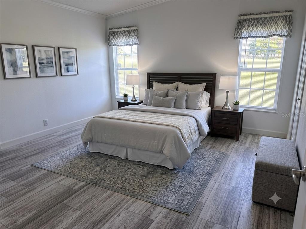 A kitchen features white cabinets, a marble-patterned island, stainless steel appliances, and dark tile backsplash — 3496 GREENBLUFF ROAD UNIT 1118, ZELLWOOD, FL