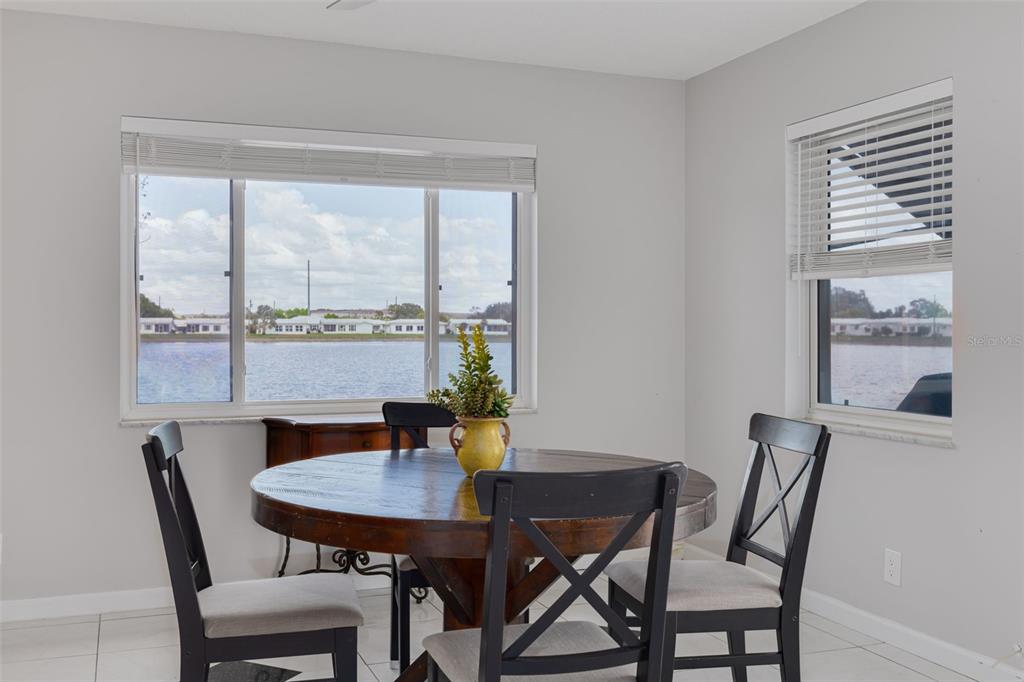 A living room features two blue armchairs, a beige armchair, and a central ottoman — 9705 MAINLANDS BOULEVARD W, PINELLAS PARK, FL
