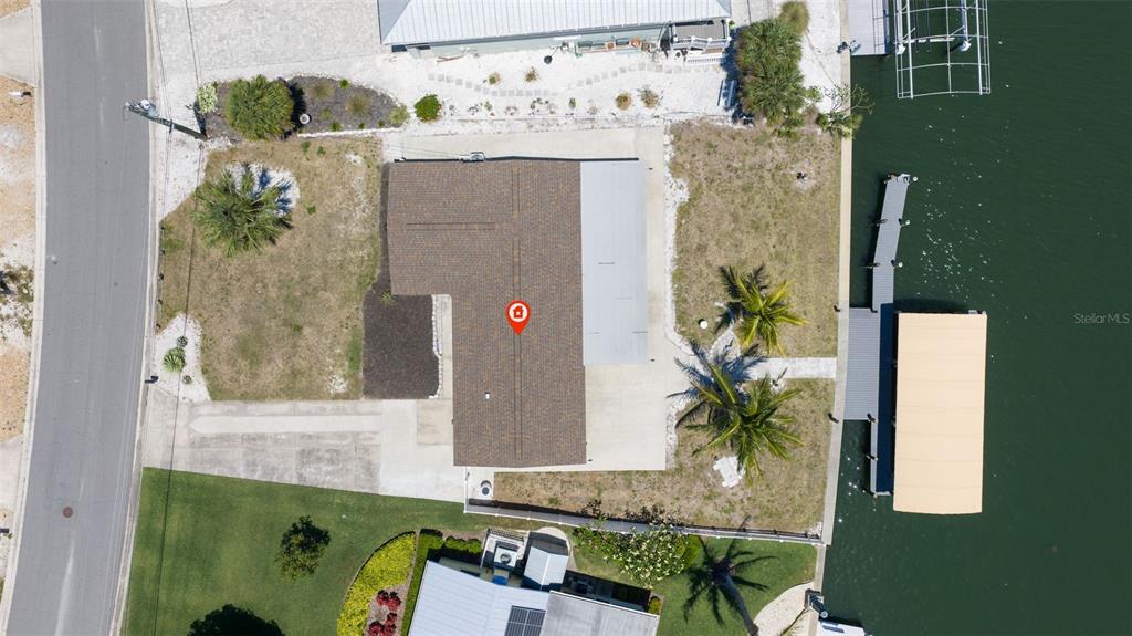 An aerial view of a waterfront house with a boat dock and lift — 5108 COMMONWEALTH ROAD, PALMETTO, FL
