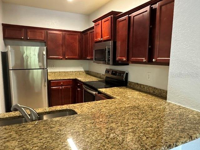 A bathroom features a tiled tub-shower combo, a vanity with a mirror, and tile flooring — 126 VISTA VERDI CIRCLE UNIT 204, LAKE MARY, FL