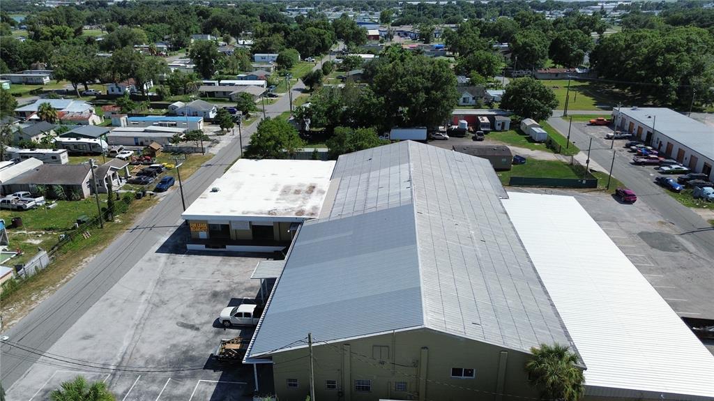 An aerial view shows a large industrial building with a metal roof and parking lot — 936 EDITH AVENUE, LAKELAND, FL