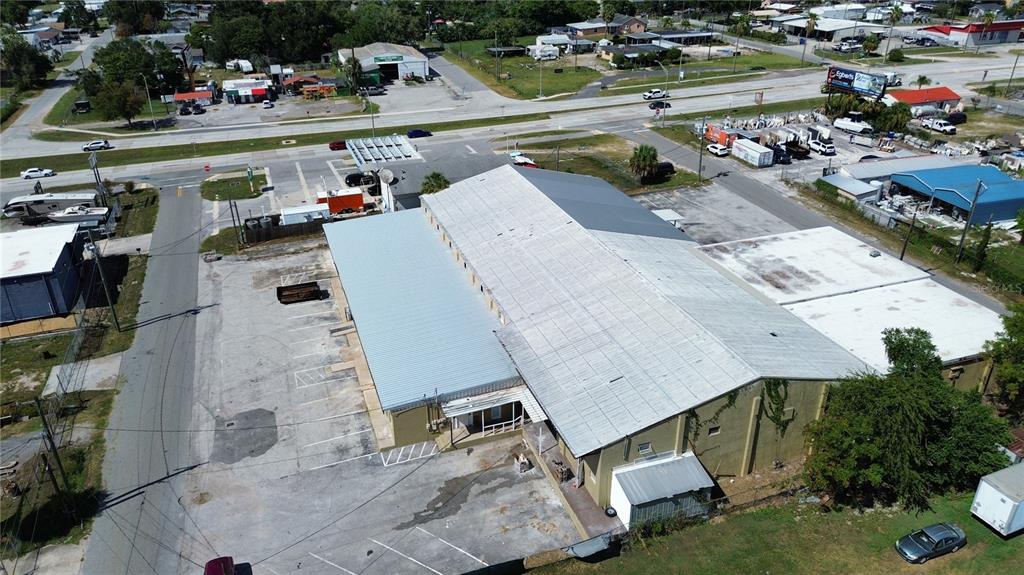 An aerial view shows a large commercial building with a metal roof and parking lot — 936 EDITH AVENUE, LAKELAND, FL