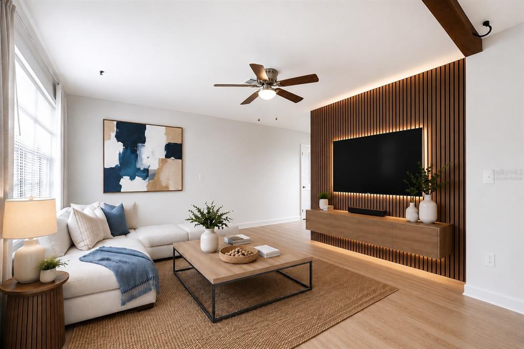 A living room features a white sectional sofa, a wood coffee table, and a slatted wall — 5018 LILLILEA LANE, NEW PORT RICHEY, FL