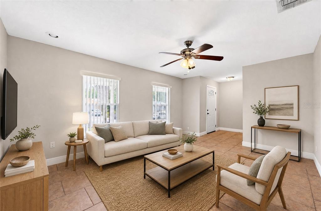 A living room features a beige sofa, a wooden coffee table, and tile flooring — 6045 WEDGEWOOD CIRCLE, ORLANDO, FL