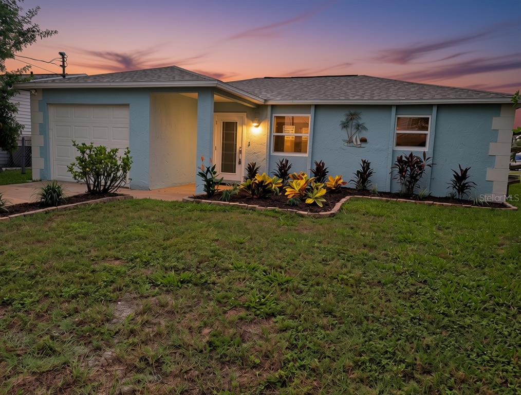 A kitchen sink with a gooseneck faucet overlooks a canal and residential neighborhood — 6432 BOATYARD DRIVE, HUDSON, FL