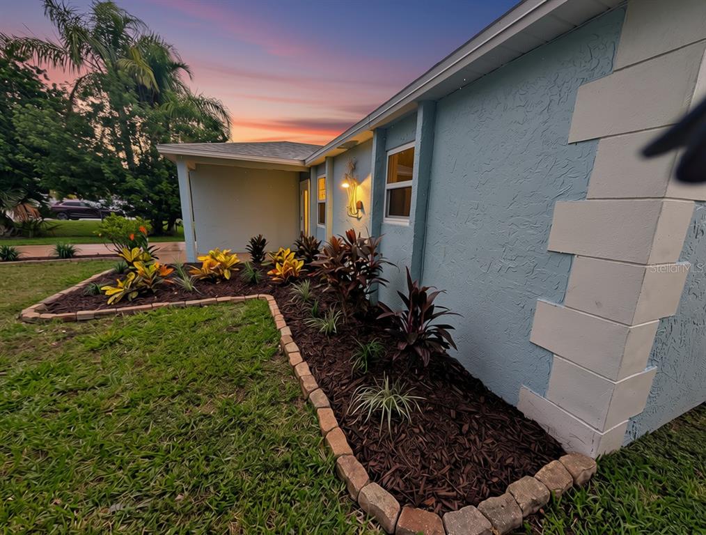 A bathroom features a white vanity, a toilet, and a walk-in shower with blue tiles — 6432 BOATYARD DRIVE, HUDSON, FL