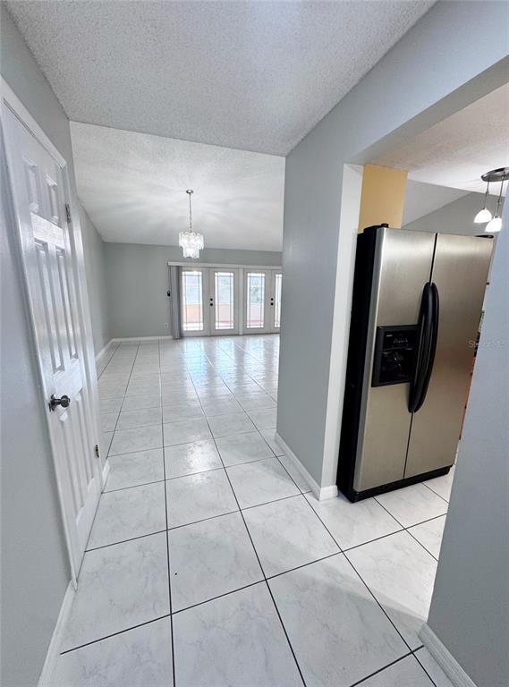 A single-story house with a white garage, gray siding, and a green lawn under trees — 12225 PANTAR STREET, ORLANDO, FL