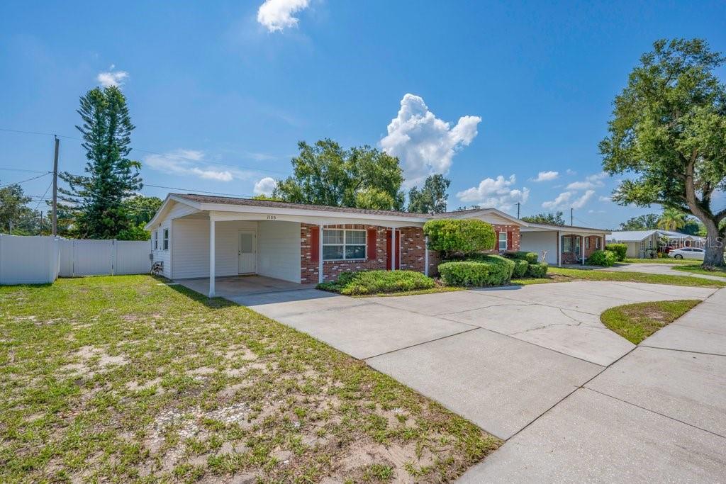 A single-story house with a brick facade, white siding, and a concrete driveway — 1105 N PARSONS AVENUE, BRANDON, FL