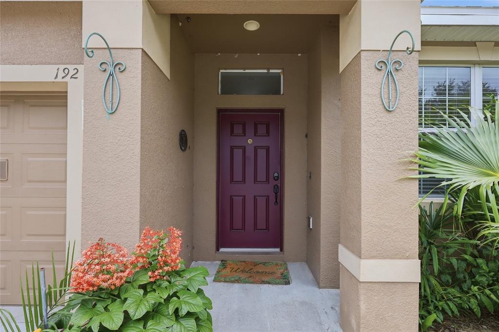A tiled entryway features light gray walls, a white front door, and a ceiling light — 192 BLACKSTONE CREEK ROAD, GROVELAND, FL
