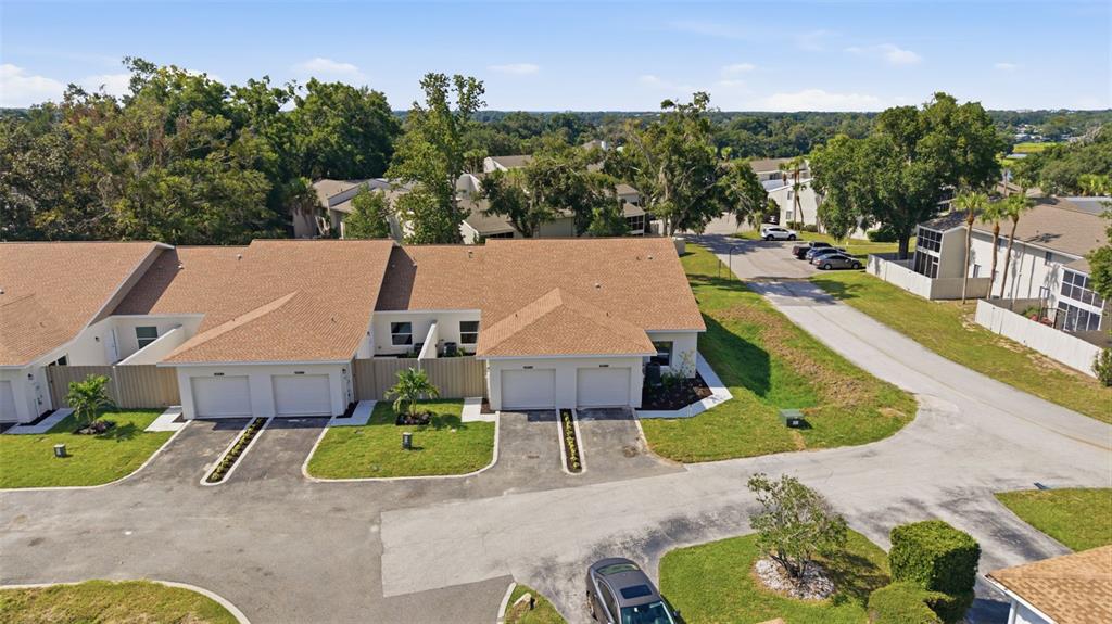 This is a rendering of a row of single-story residential units with attached garages — 1411 OAK PL UNIT B, APOPKA, FL