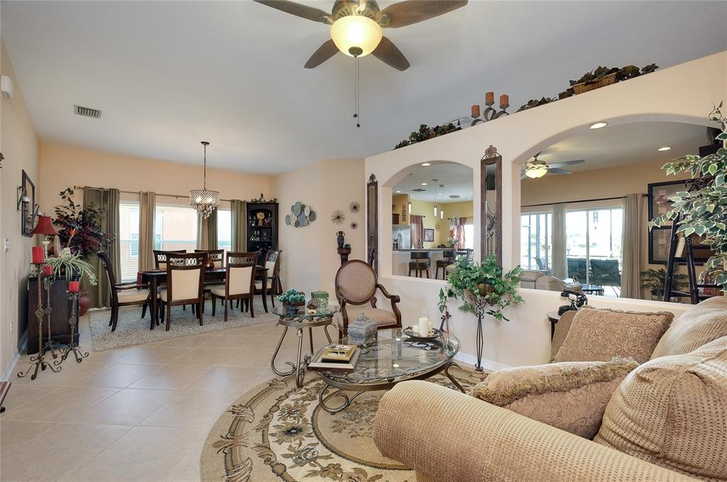 A front entryway features a dark door with a glass insert, stone siding, and a planter — 7830 113TH AVENUE E, PARRISH, FL