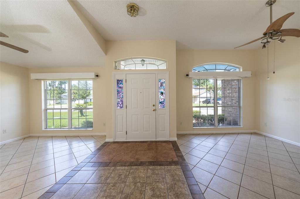 An entryway with tile flooring, a front door with sidelights, and windows on both sides — 22 EMERSON DRIVE, PALM COAST, FL