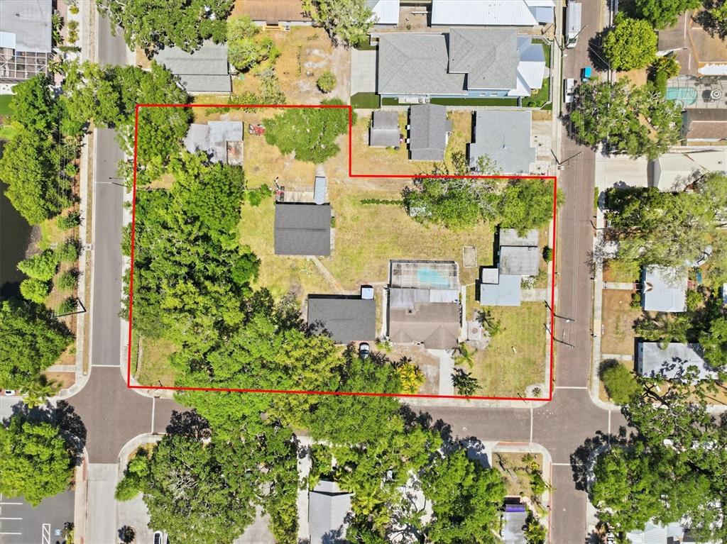 This aerial view shows a residential property lot outlined in red with multiple structures — 515 2ND STREET N, SAFETY HARBOR, FL