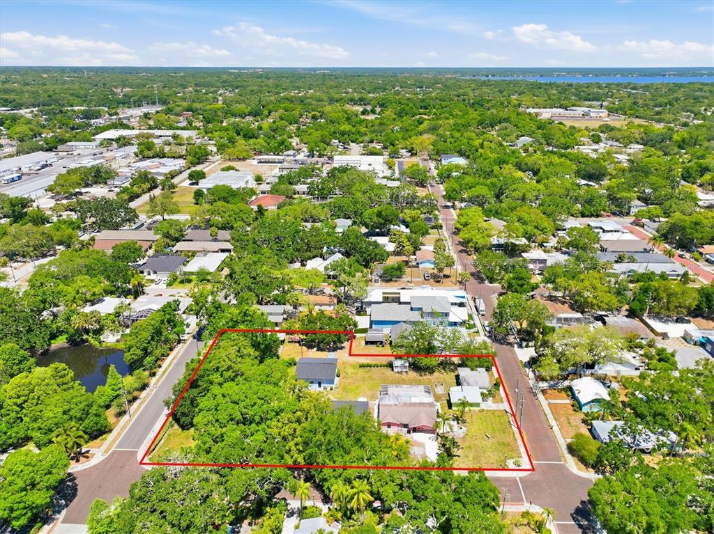 An aerial view shows a residential lot outlined in red containing two houses and trees — 515 2ND STREET N, SAFETY HARBOR, FL
