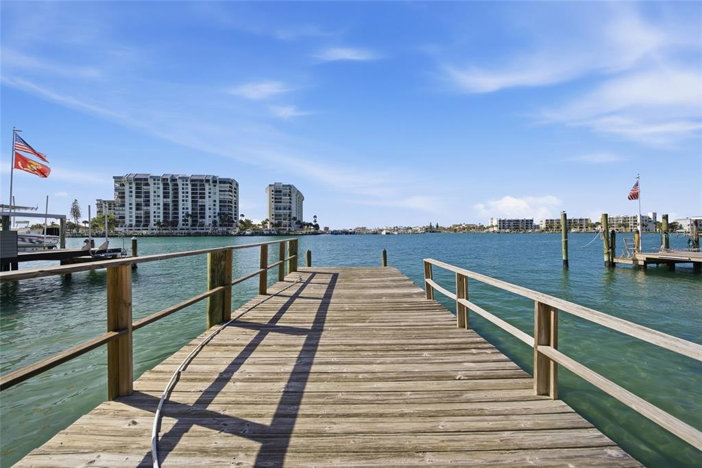 A single-story brick house with a tiled roof, a cracked driveway, and a front garden — 4 BELLEVUE DRIVE, TREASURE ISLAND, FL