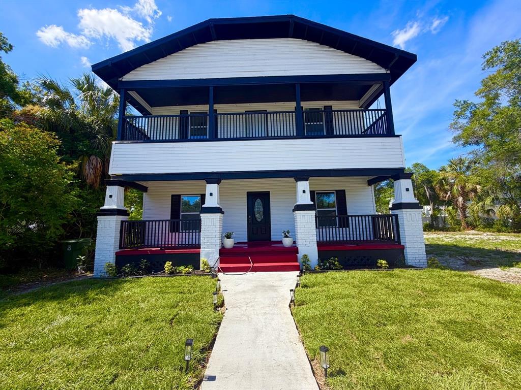 A two-story house with a white exterior, black trim, and a covered front porch — 2610 W CYPRESS STREET, TAMPA, FL