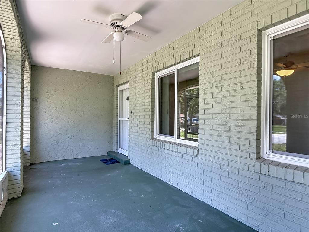 A swimming pool is enclosed by a screened lanai with a concrete deck and trees — 1237 JEFFERY DRIVE, PORT ORANGE, FL